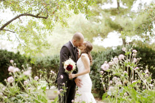 This Columbus Ohio bride and groom exchange a kiss at the Franklin Park Conservatory photographed by Red Gallery Photography.
